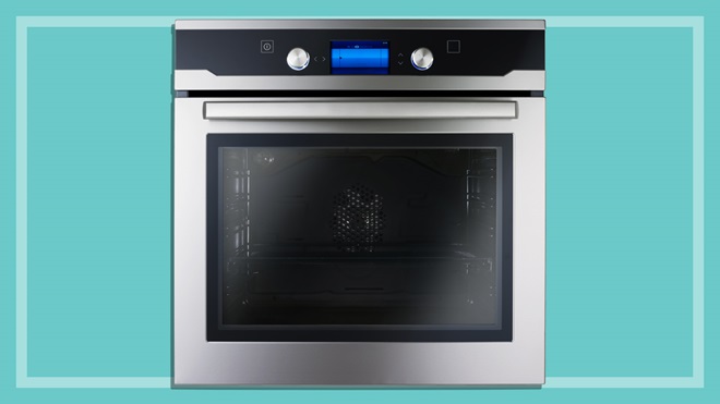 silver wall oven on a teal background
